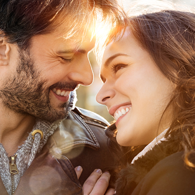 Portrait of happy young couple looking at each other and smiling outdoor